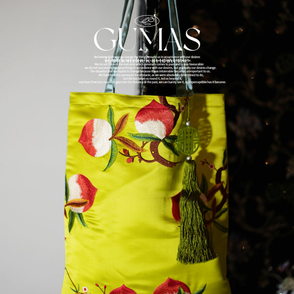 Lime green silk embroidered decorative pouch with red and white floral design and olive tassel