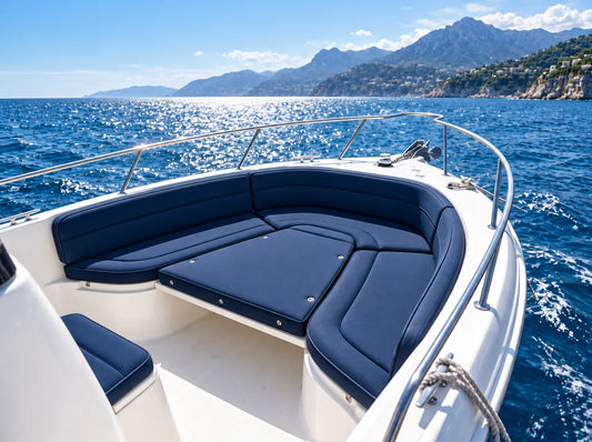Navy blue custom cushions on a boat bow lounge on a sunny day