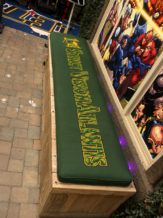 Custom branded gym bench cushion with 1% Strict Vision Atlantis logo sublimation printed on green fabric installed on wooden bench