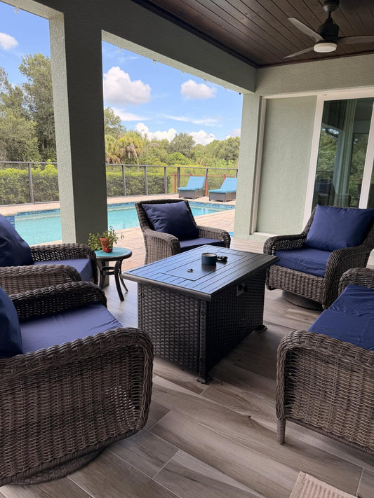 Blue custom deep seat cushion set on patio wicker furniture by a pool