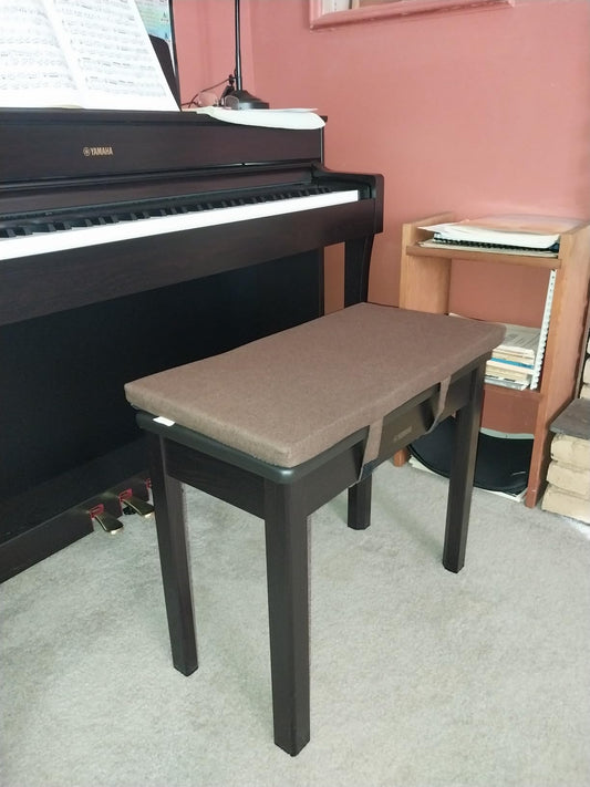 Custom brown velvet piano bench cushion on a Yamaha upright in a home music room