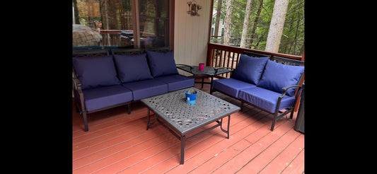 Replacement navy deep seat cushions on an outdoor sofa and loveseat