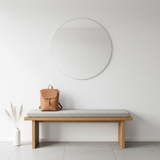 Navy blue patterned 47 x 17 bench cushion on patio furniture surrounded by plants