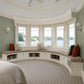 Custom curved bay window seat cushion for a built-in storage bench