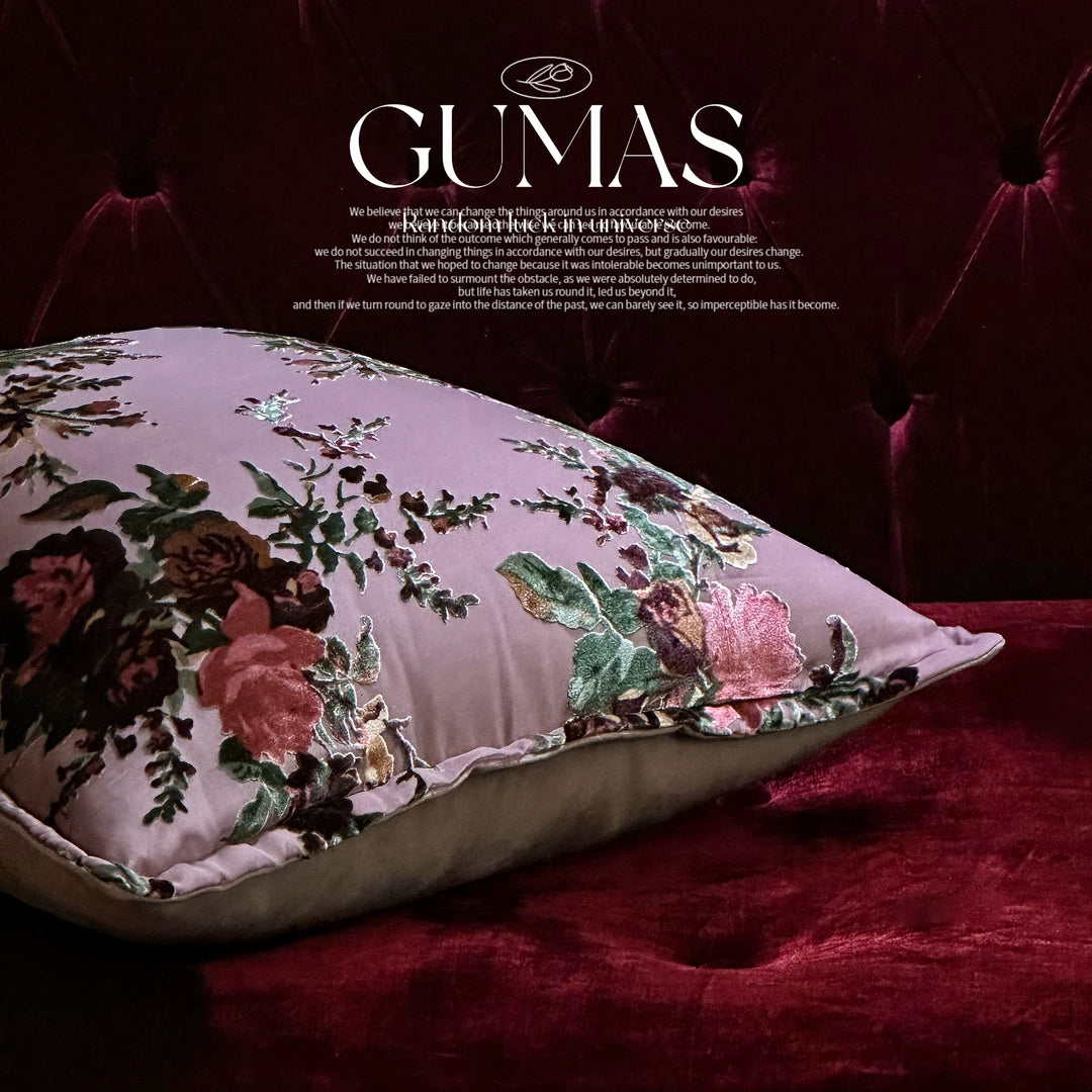 mauve silk velvet rose floral cushion on tufted sofa