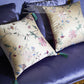 pair of champagne silk embroidered peony throw pillows on sofa