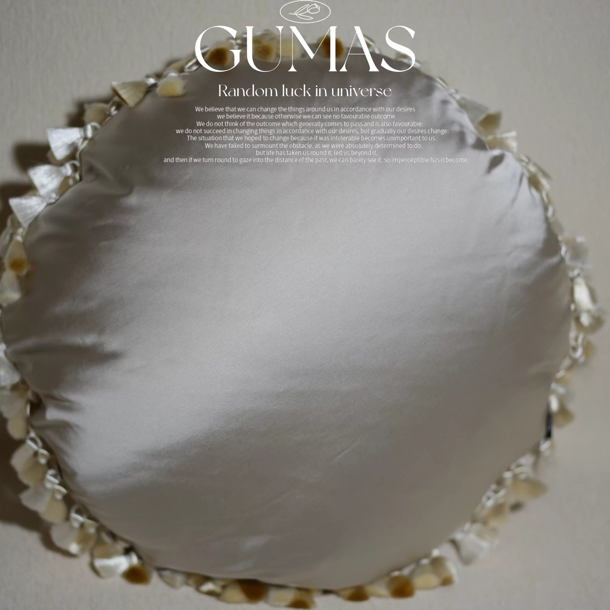 cream round satin pillow back with tassel trim