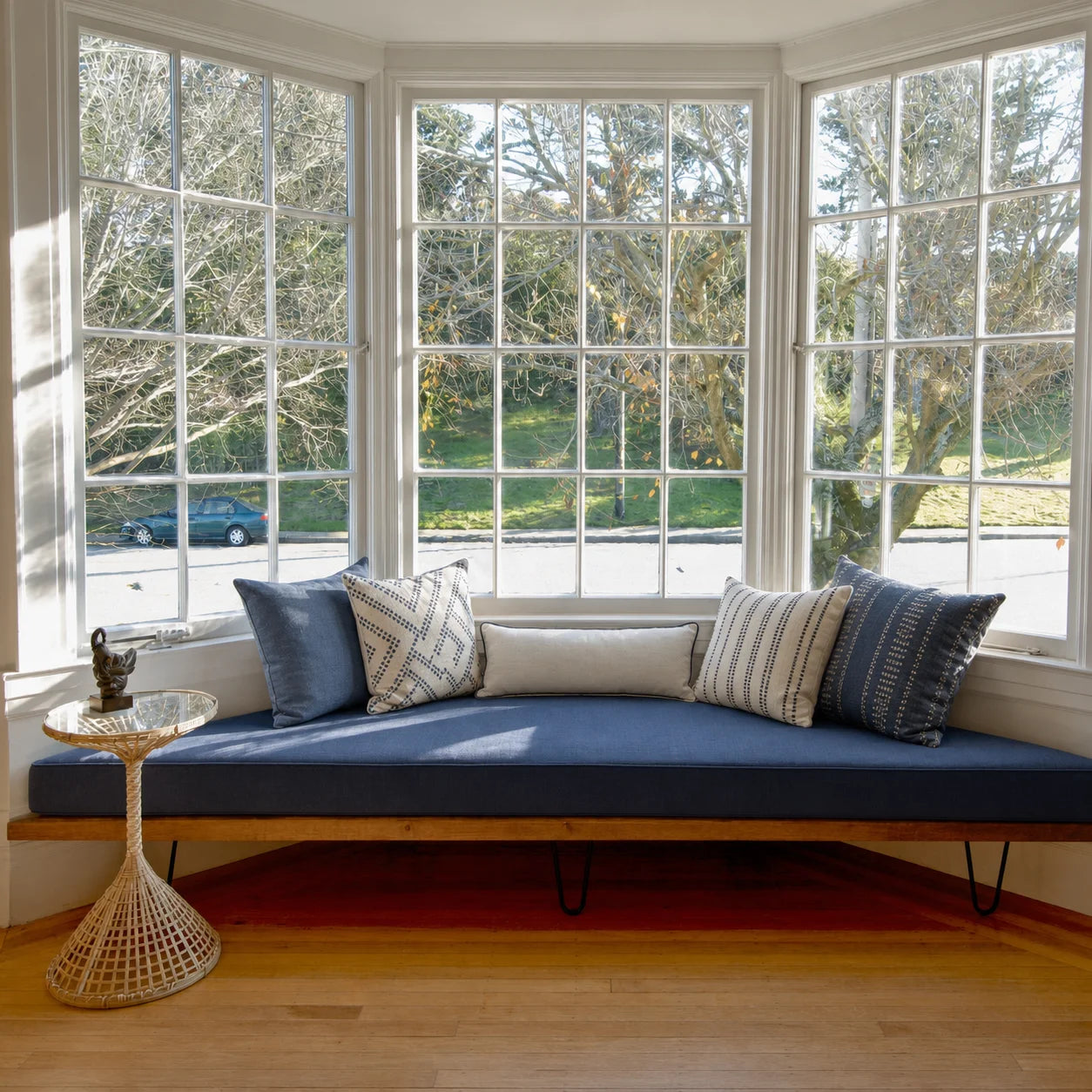 Custom navy bay window seat cushions on a built-in bench