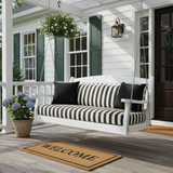 48 x 15 outdoor bench cushion in deep navy with subtle patterns, placed in a stylish patio setting.