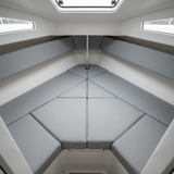 Nautical-themed boat interior with stylish navy and teal seat cushions