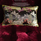 Chinoiserie pillow cover with gold tassel trim and black accent border on wine red velvet base