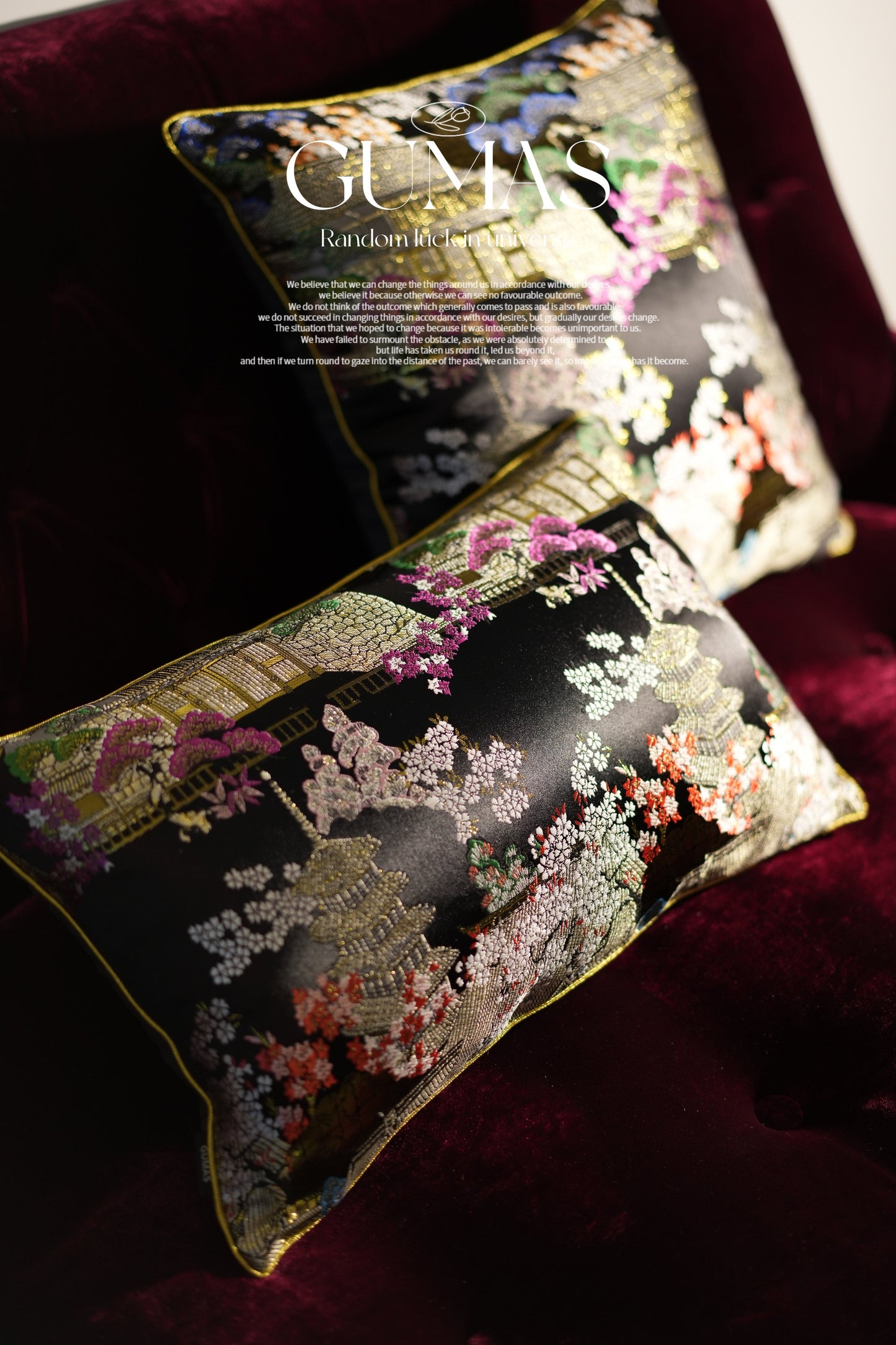 Close-up of gold metallic embroidery showing flowering trees and pavilion details on burgundy velvet cushion
