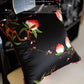 Close-up of hand-embroidered red bell-shaped flowers on silk pillow cover