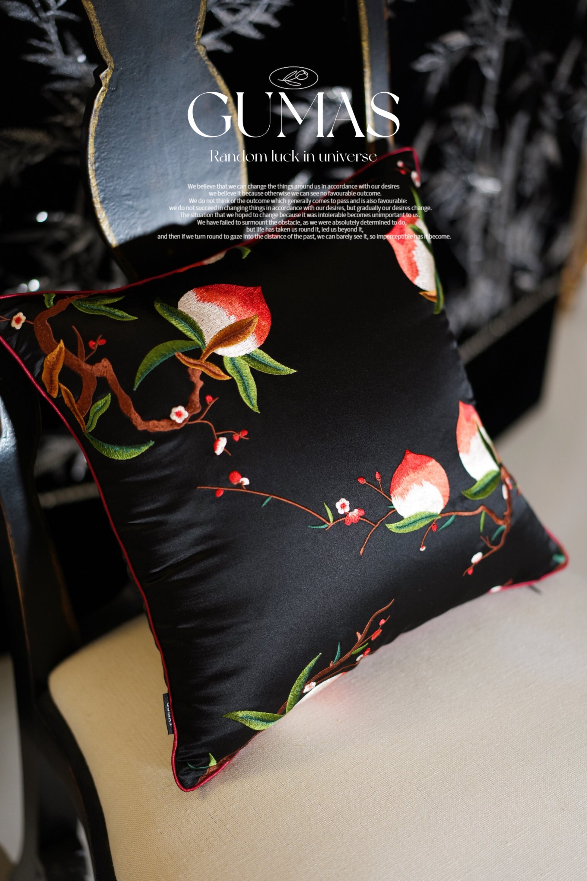 Close-up of hand-embroidered red bell-shaped flowers on silk pillow cover
