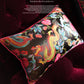 Close-up of metallic gold dragon embroidery with pink roses and blue leaves on black silk panel