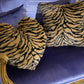 Close-up of tiger stripe plush velvet texture showing furry pile detail in gold and black
