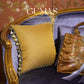 Close up of vintage botanical bird and fern pattern on gold brocade pillow with purple tassel fringe detail