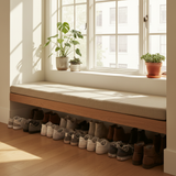 A long bench adorned with rich teal cushions in a beautifully landscaped garden.