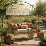 A cozy cushion patio swing in deep teal color hanging in a sunny backyard