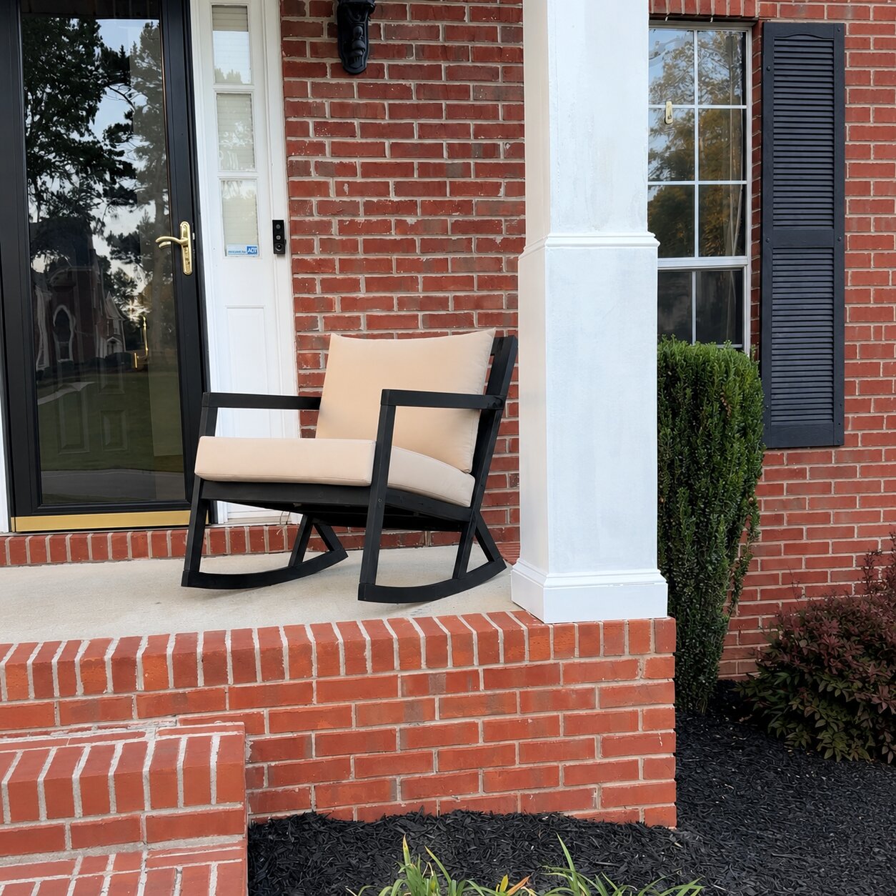 Custom beige porch rocking chair cushion for a black wood rocker
