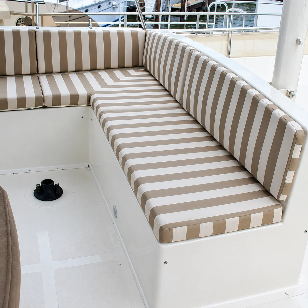 Custom beige striped boat cockpit cushions for yacht bench seating