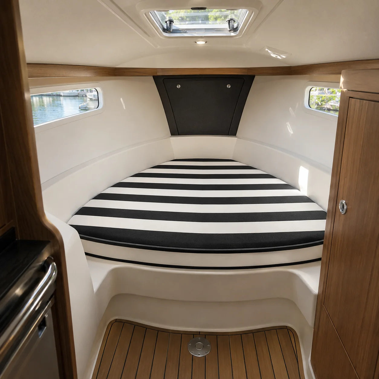 Custom black and white striped boat V-berth cushion for a cabin bed