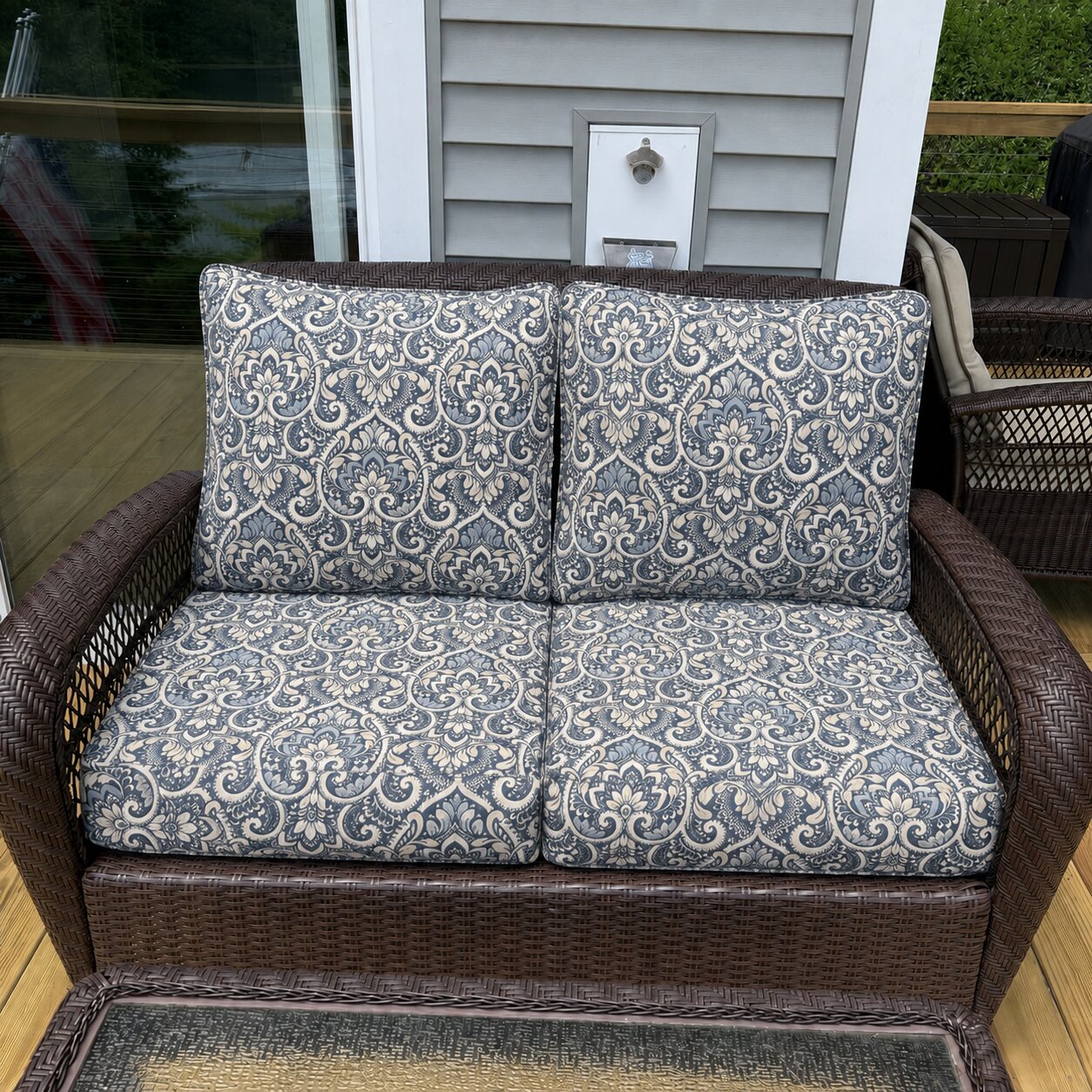 Custom blue damask wicker loveseat cushions for an outdoor patio