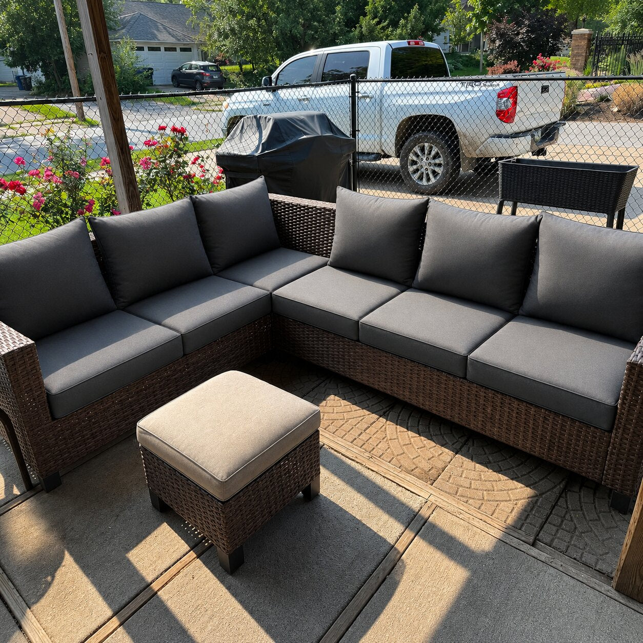 Custom dark gray outdoor sectional cushions with a patio ottoman