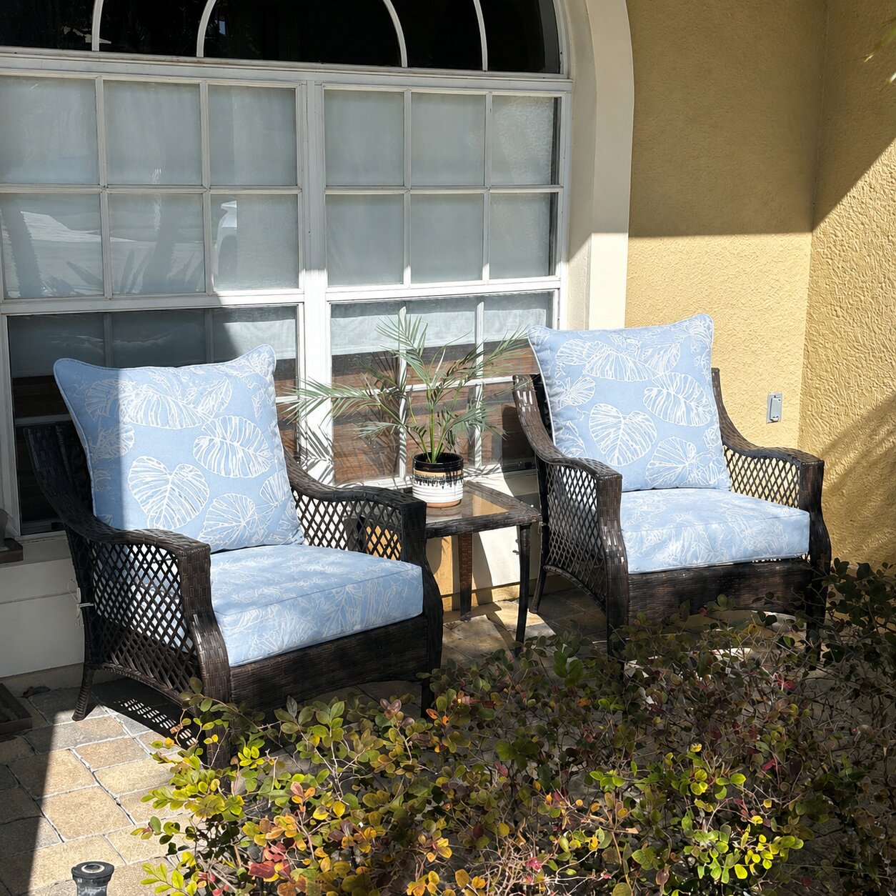 Custom light blue tropical leaf wicker chair cushions for a patio