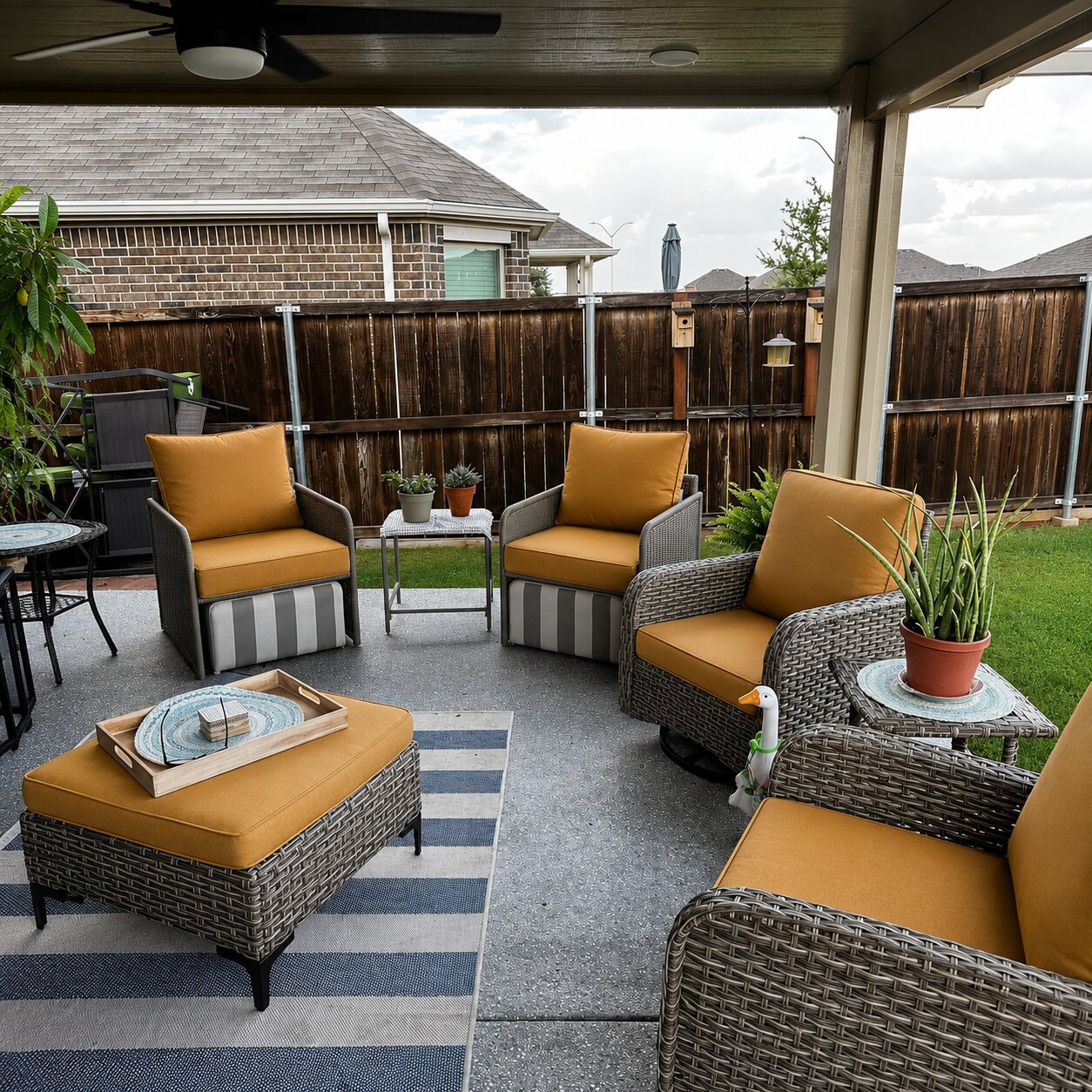 Custom mustard yellow wicker patio chair cushions with an ottoman