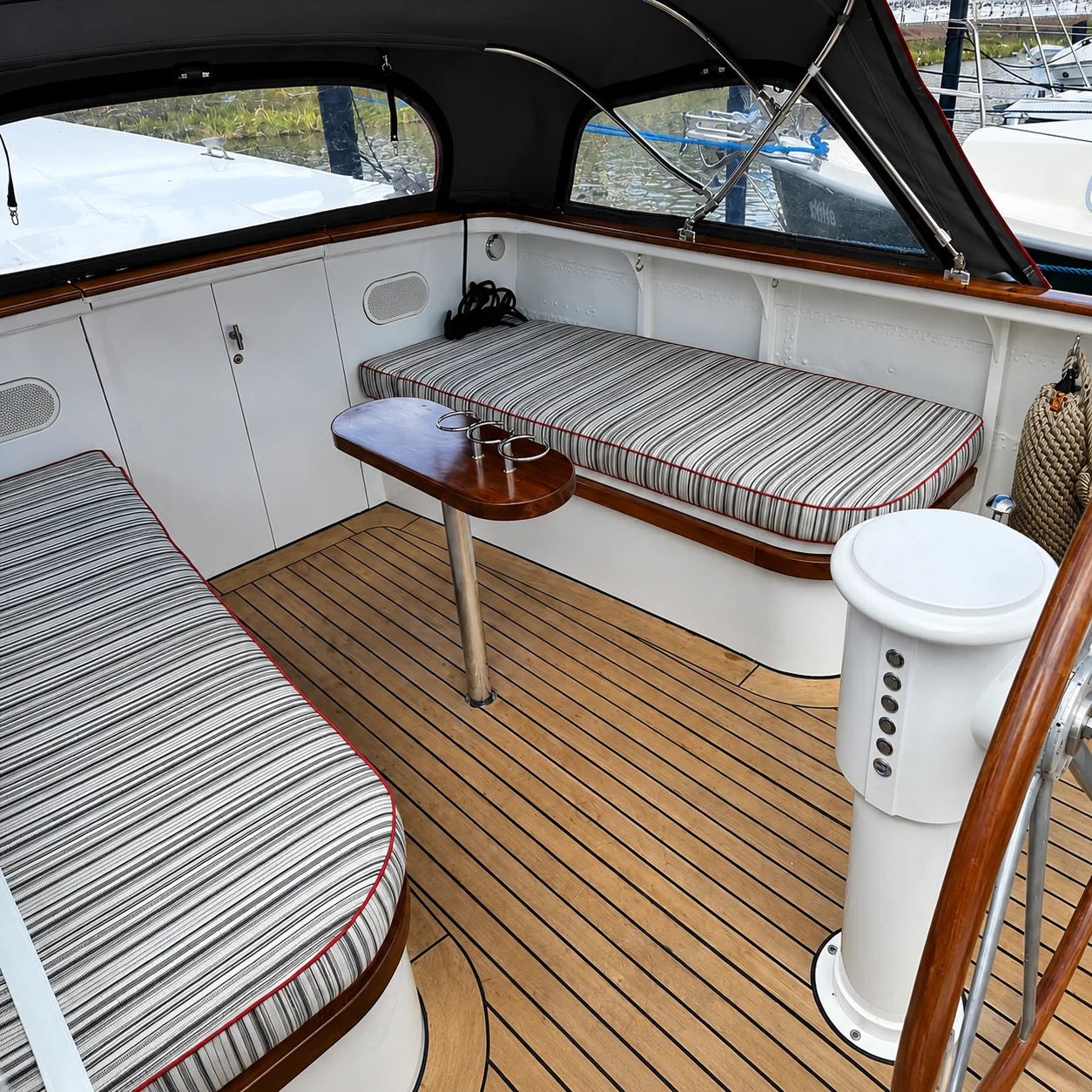 Custom striped boat cockpit cushions for a yacht seating area