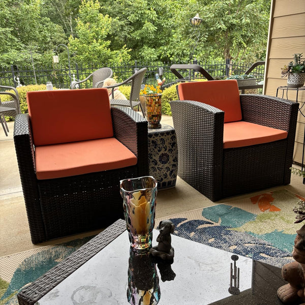 Custom orange deep seat cushions on wicker patio chairs