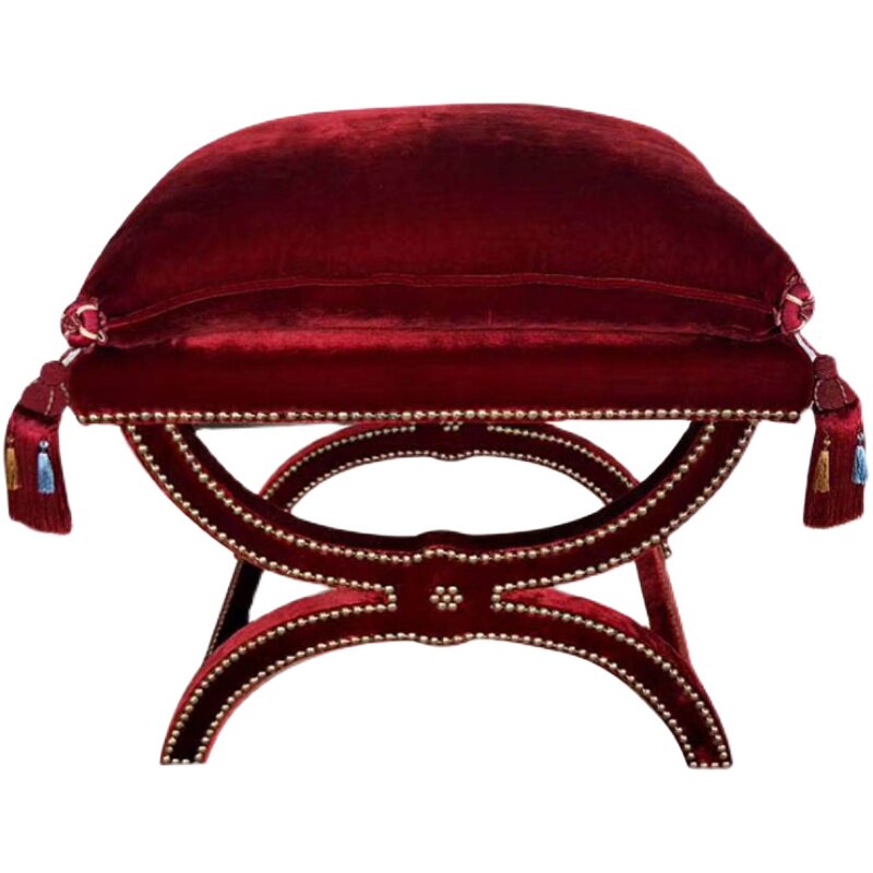 Gold beading and curved edge detail on neoclassical burgundy velvet ottoman cover