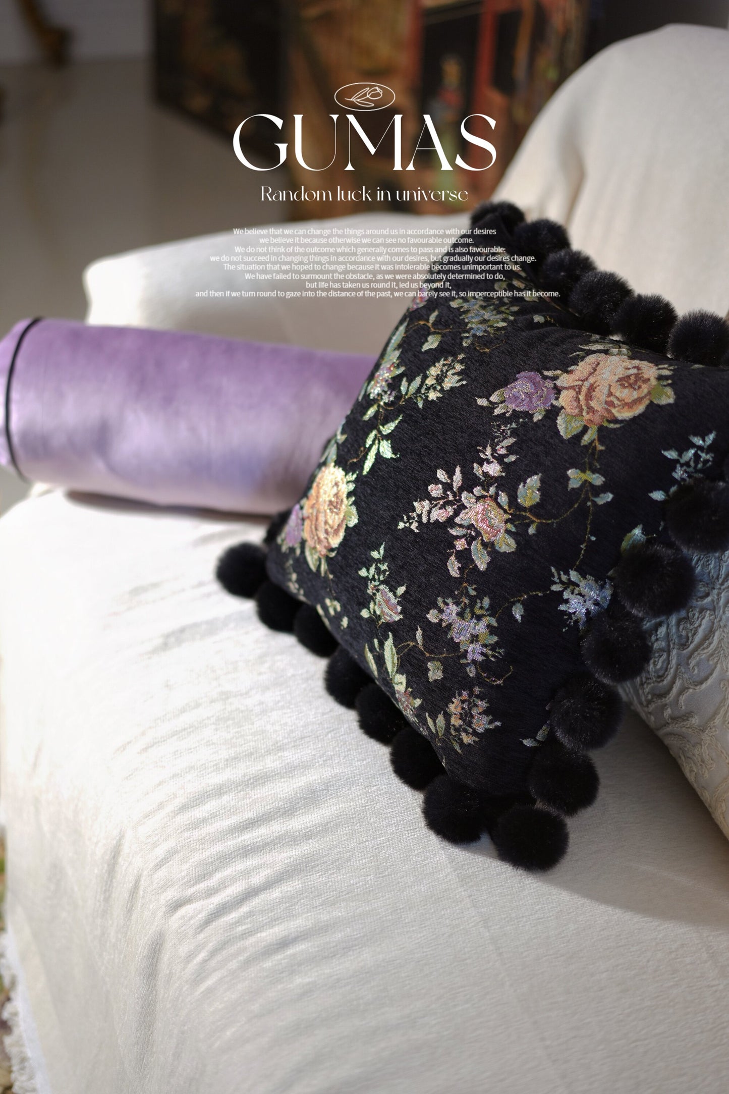 Hand-stitched rose embroidery detail on black chenille pillow with gold and purple floral pattern