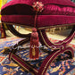Hand-tied burgundy and gold tassels on luxury velvet ottoman bench cover