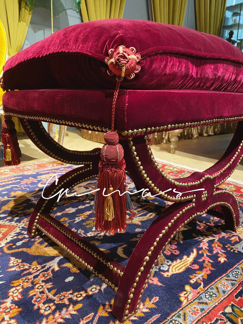 Hand-tied burgundy and gold tassels on luxury velvet ottoman bench cover