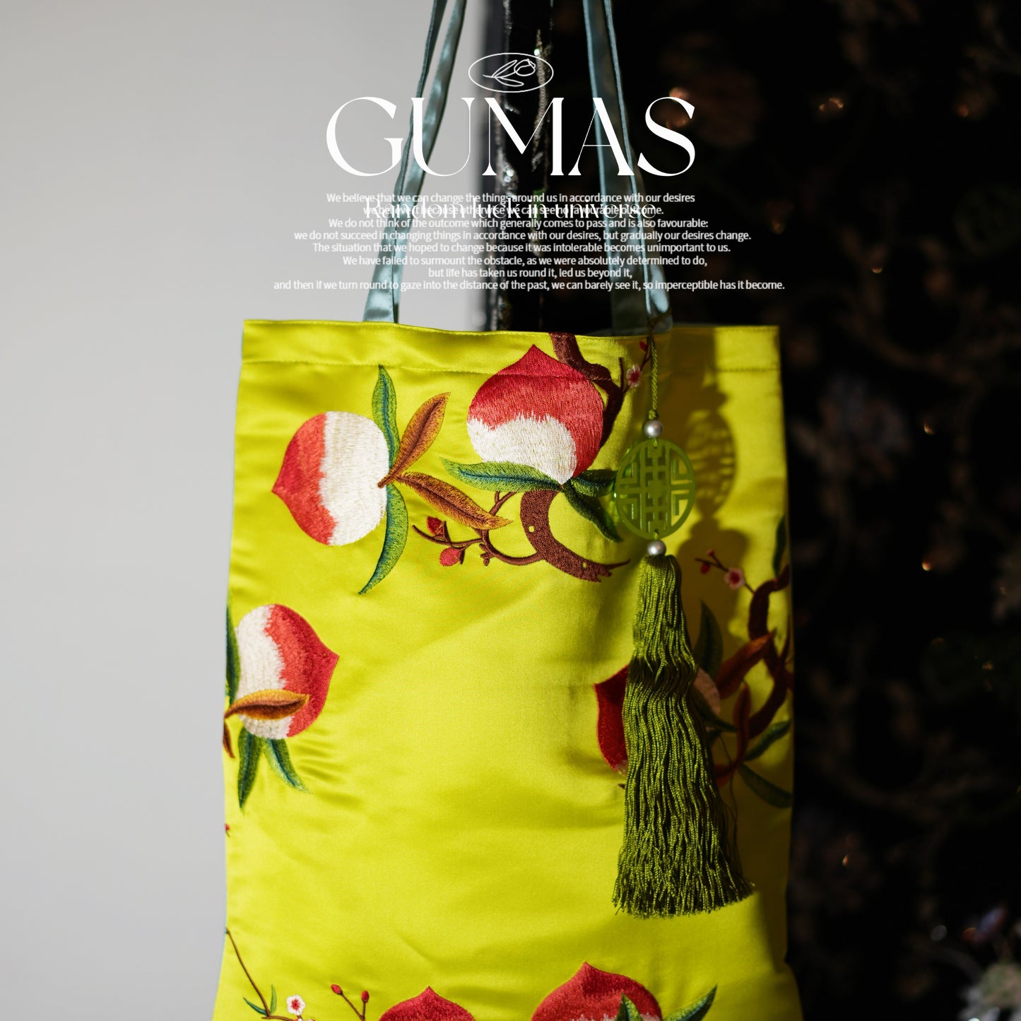 Lime green silk embroidered decorative pouch with red and white floral design and olive tassel