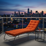 Stylish lounge chaise with outdoor cushions in deep indigo and forest green amidst a beautiful garden.