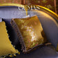 Mustard yellow solid brocade pillow cover with textured weave on ornate carved wood chair