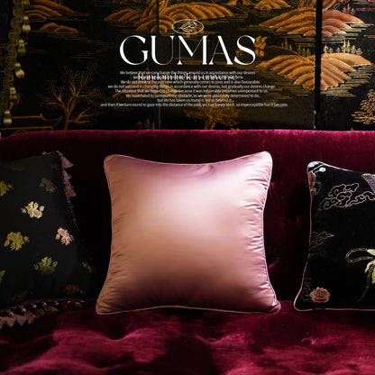 Oriental-inspired velvet pillow set with embroidered cloud scrollwork and floral motifs in burgundy living room