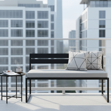 Outdoor bench cushions in modern geometric patterns, set in a vibrant garden