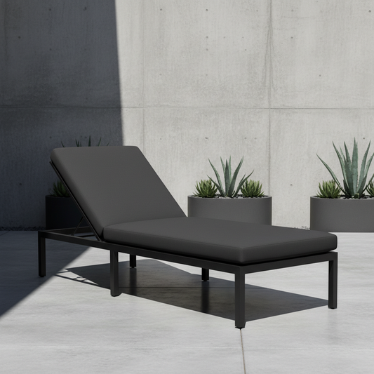 Deep navy and forest green outdoor chaise chair cushions placed in a beautiful garden