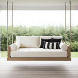 Stylish deep teal and aubergine patterned patio swing cushions in a garden