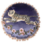 Purple embroidered tiger cushion styled on sofa showing opulent maximalist home decor