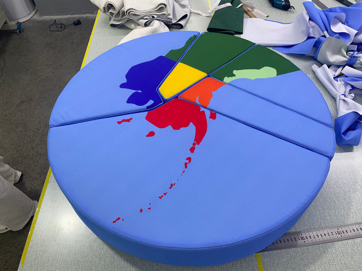 Top view of custom US map floor cushion with each state printed in color, cut into puzzle pieces