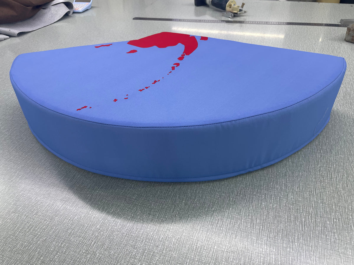 Side profile of a puzzle floor cushion piece showing the firm foam thickness