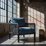 Deep cushion sectional sofa in navy blue fabric, styled in a cozy modern living room