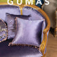 Side view of luxury velvet throw pillow showing rose gold and cream tassel fringe detail
