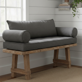 Deep navy trapezoid bench cushion on outdoor patio furniture surrounded by greenery.